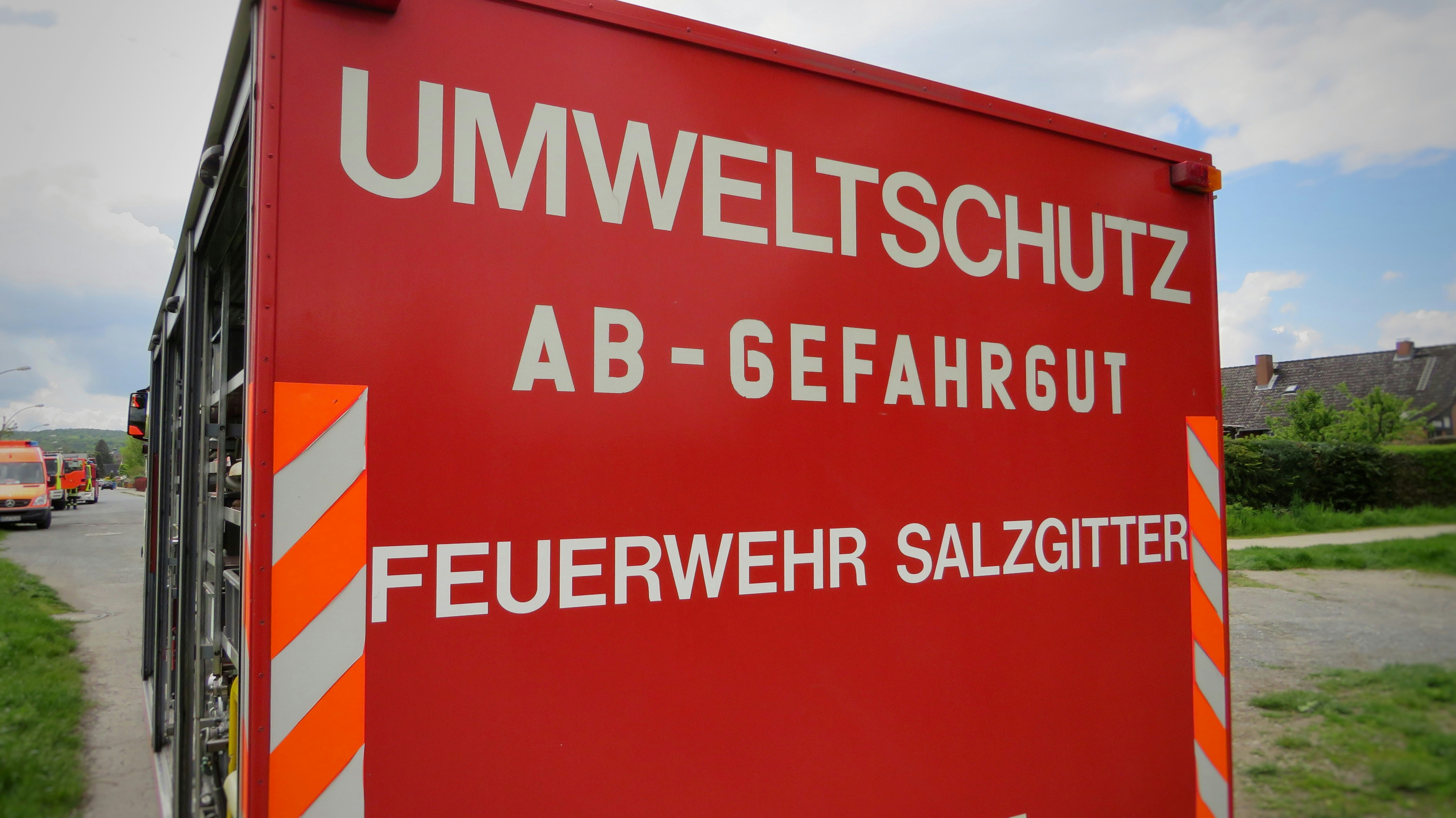 a large red sign sitting on the side of a road